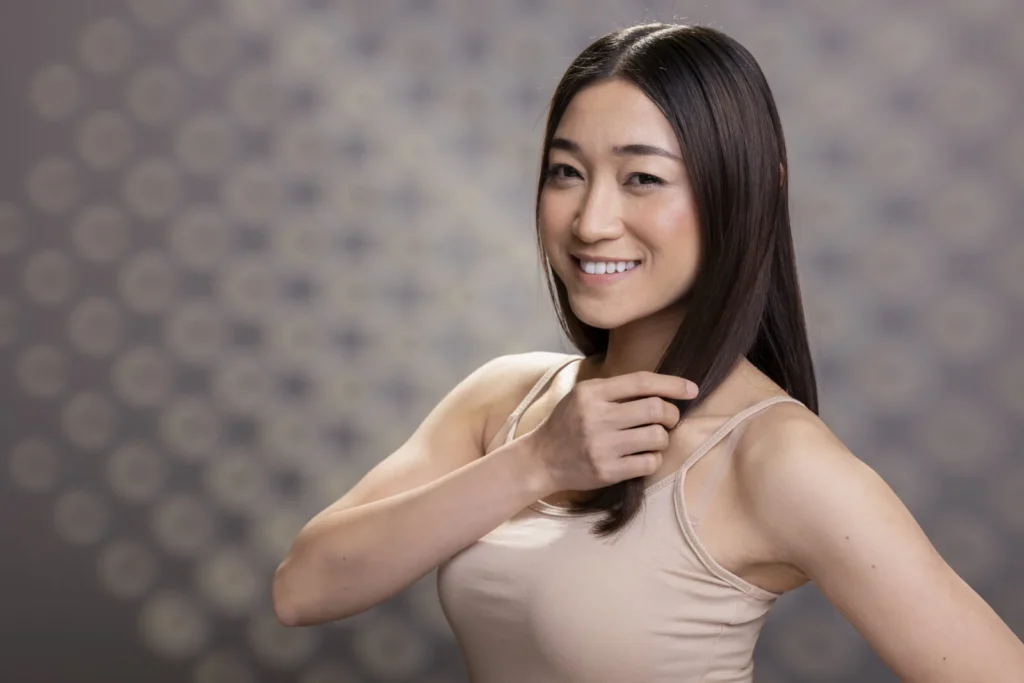 portrait smiling asian woman with flawless complexion glowing skin