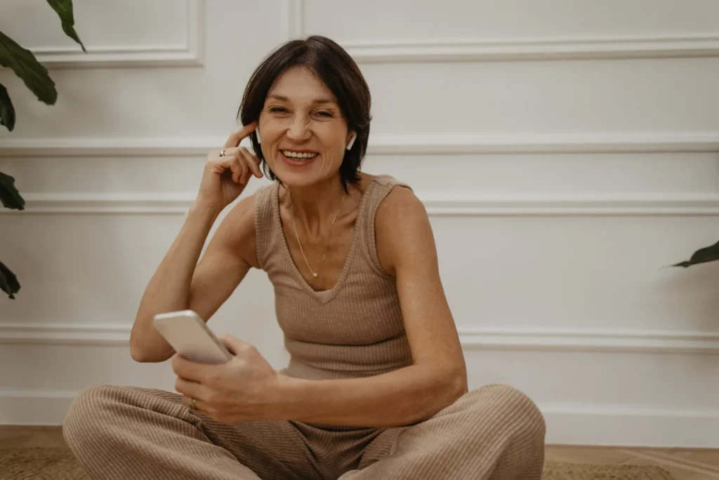 smiling adult caucasian woman enjoys ordering weekend goods phone app online shopping concept